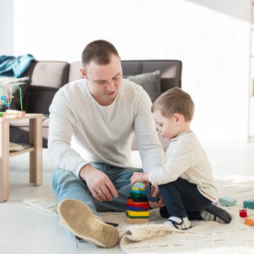 father-baby-playing-home